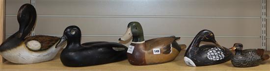 A collection of five painted palm wood decoy ducks